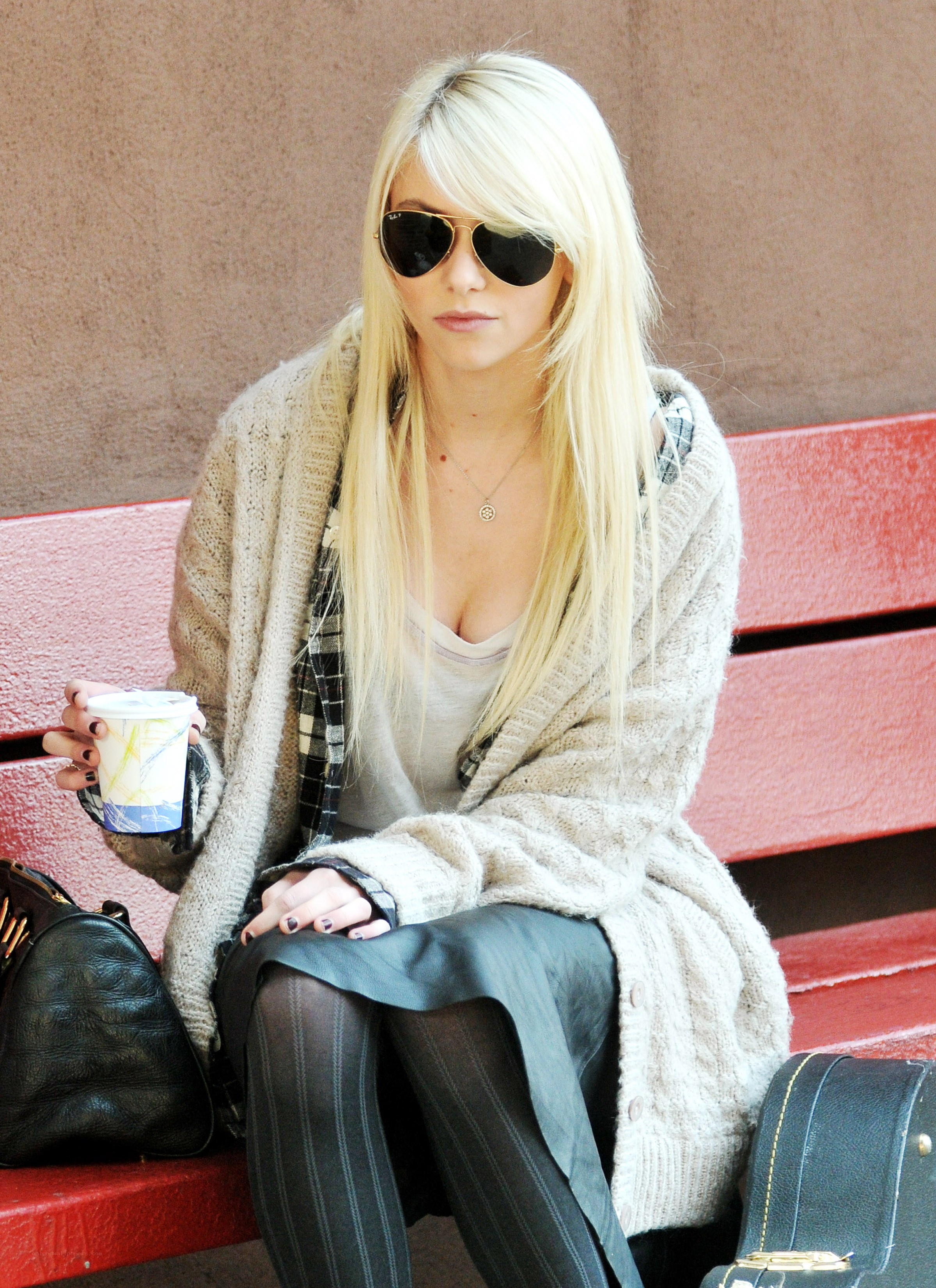 Woman with coffee on bench