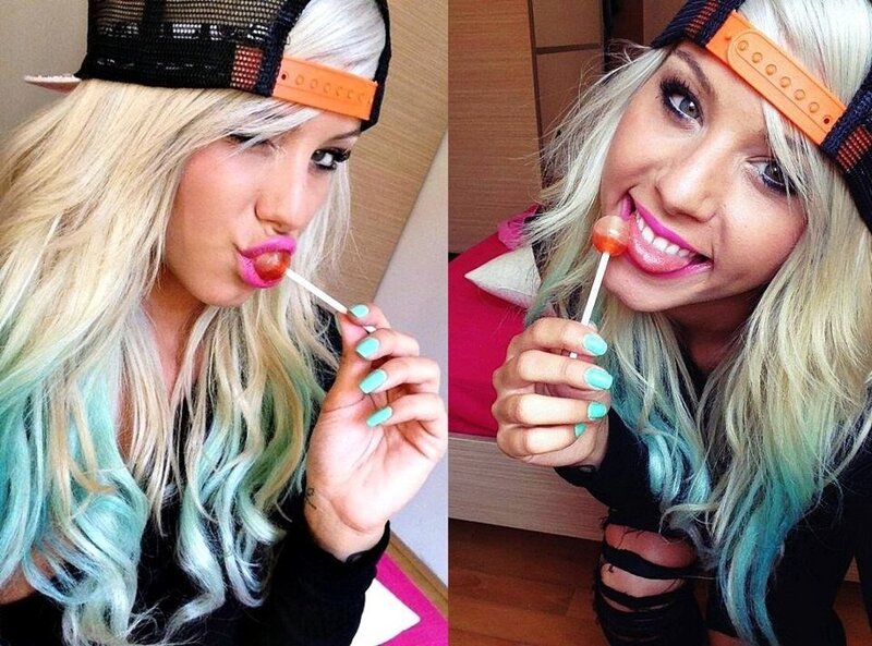 woman with colorful hair eating lollipop