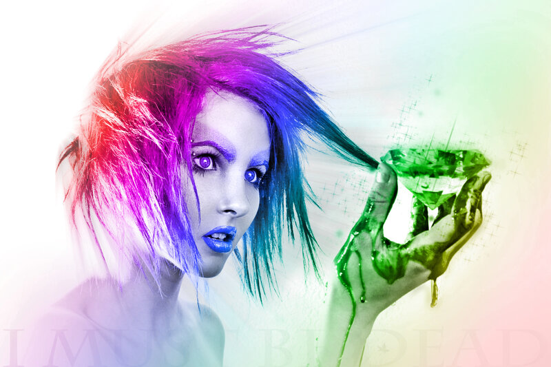 woman with colorful hair holding green gem