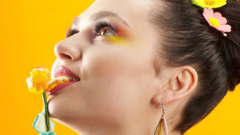 woman with colorful makeup and candy