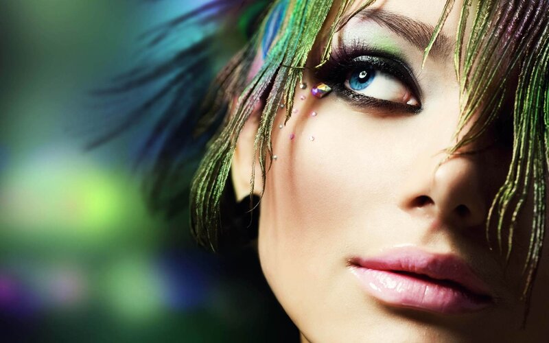 woman with colorful makeup and feathers