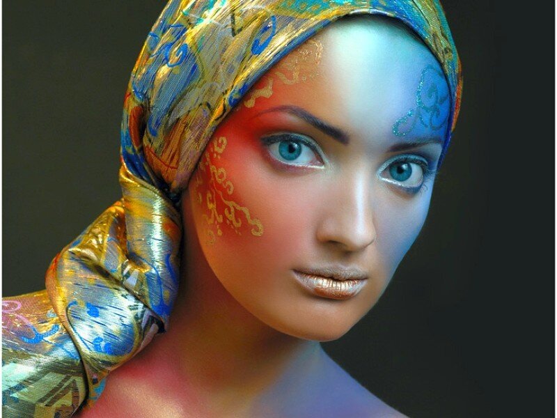 woman with colorful makeup and headscarf