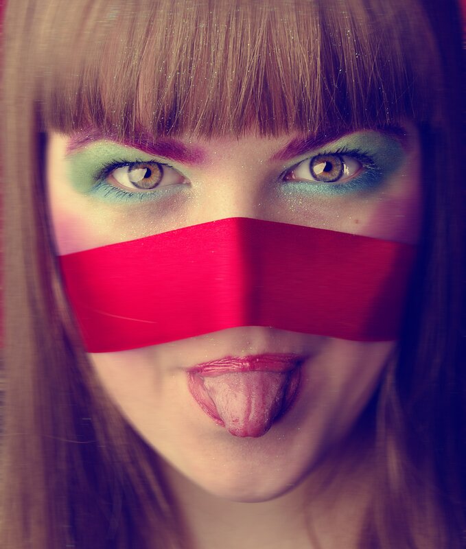 woman with colorful makeup and tape