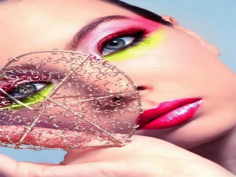 woman with colorful makeup and wire mask