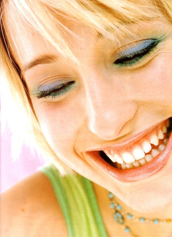 woman with colorful makeup smiling