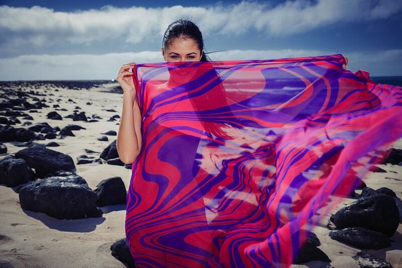 Woman with colorful scarf on beach