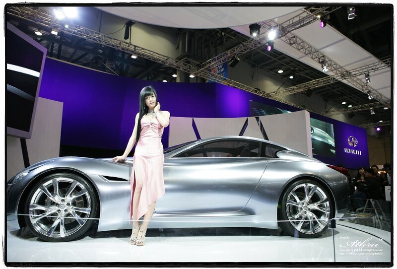 Woman with concept car at auto show