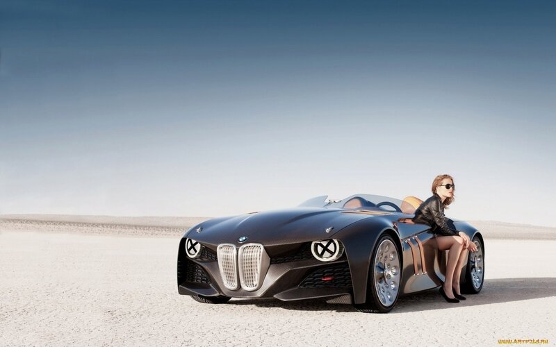 woman with concept car in desert