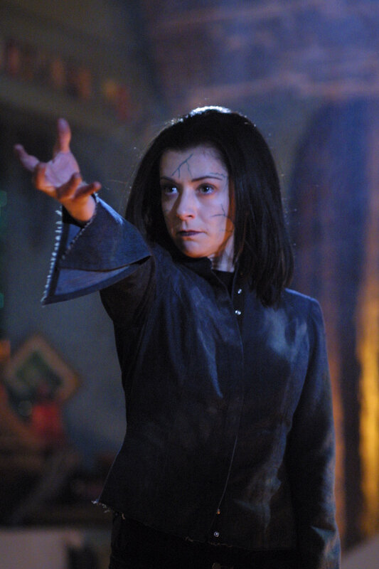 woman with cracked face casting spell