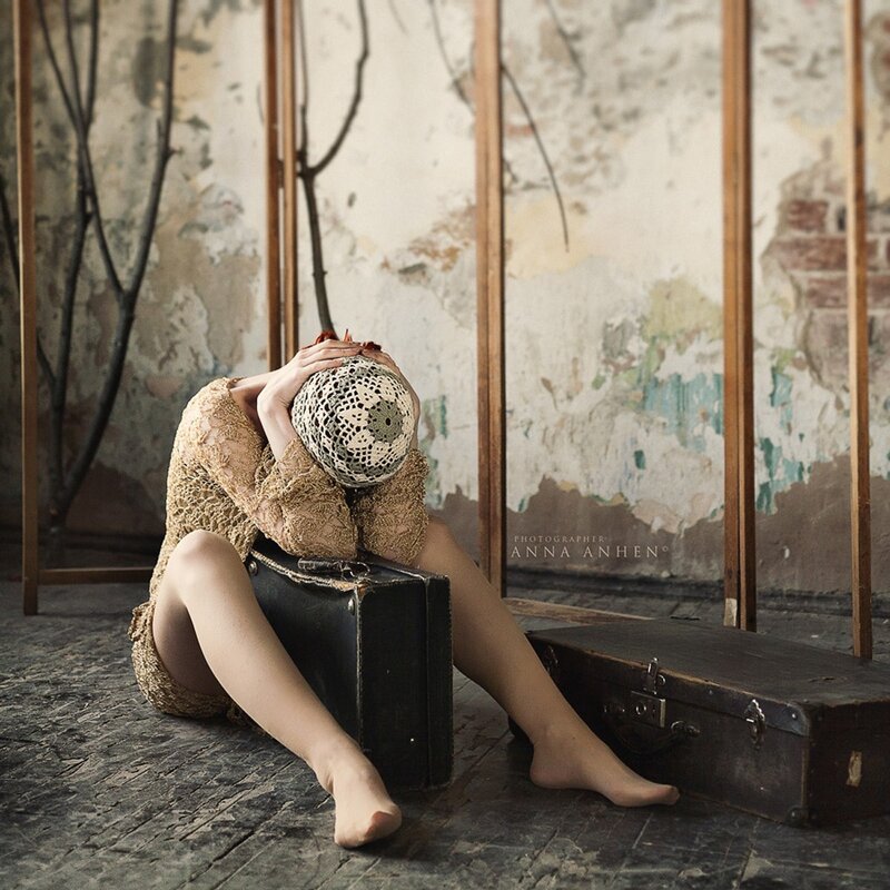 woman with crocheted mask on suitcase