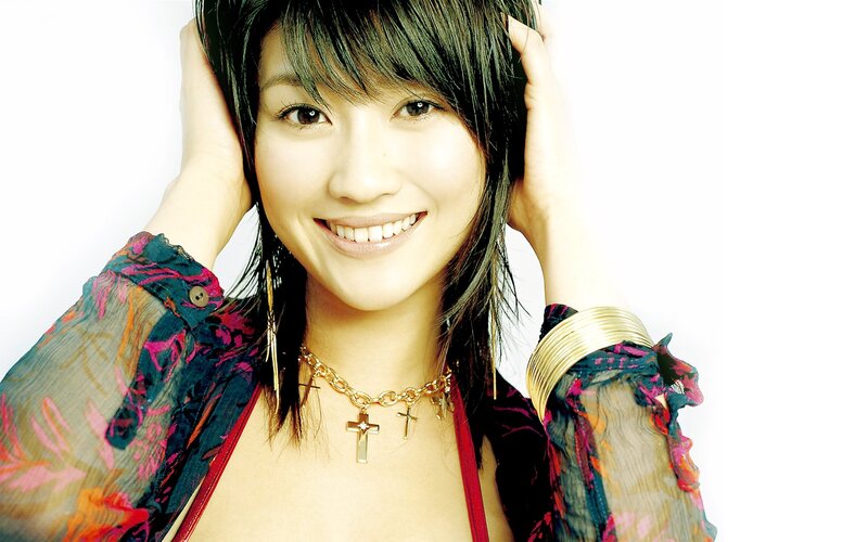 woman with cross necklace smiling