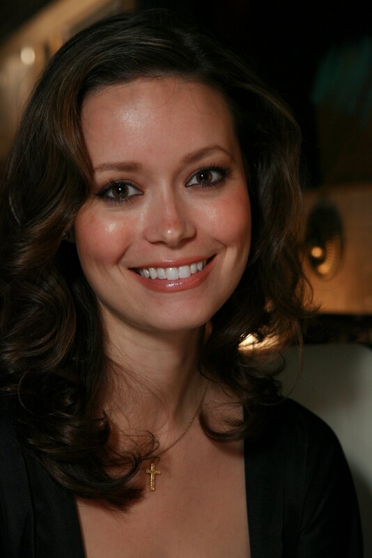 woman with cross necklace smiling