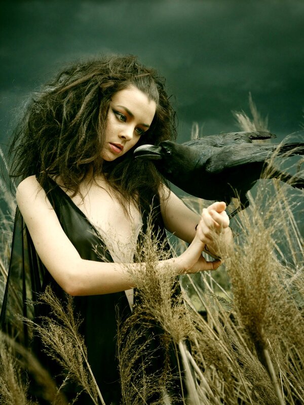 woman with crow in field