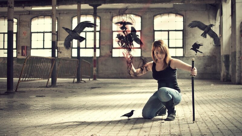Woman with crows in an abandoned building