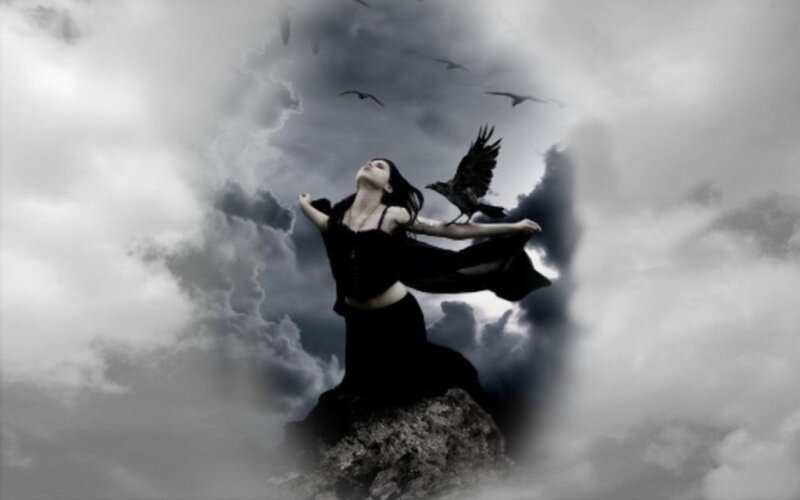 woman with crows on cliff