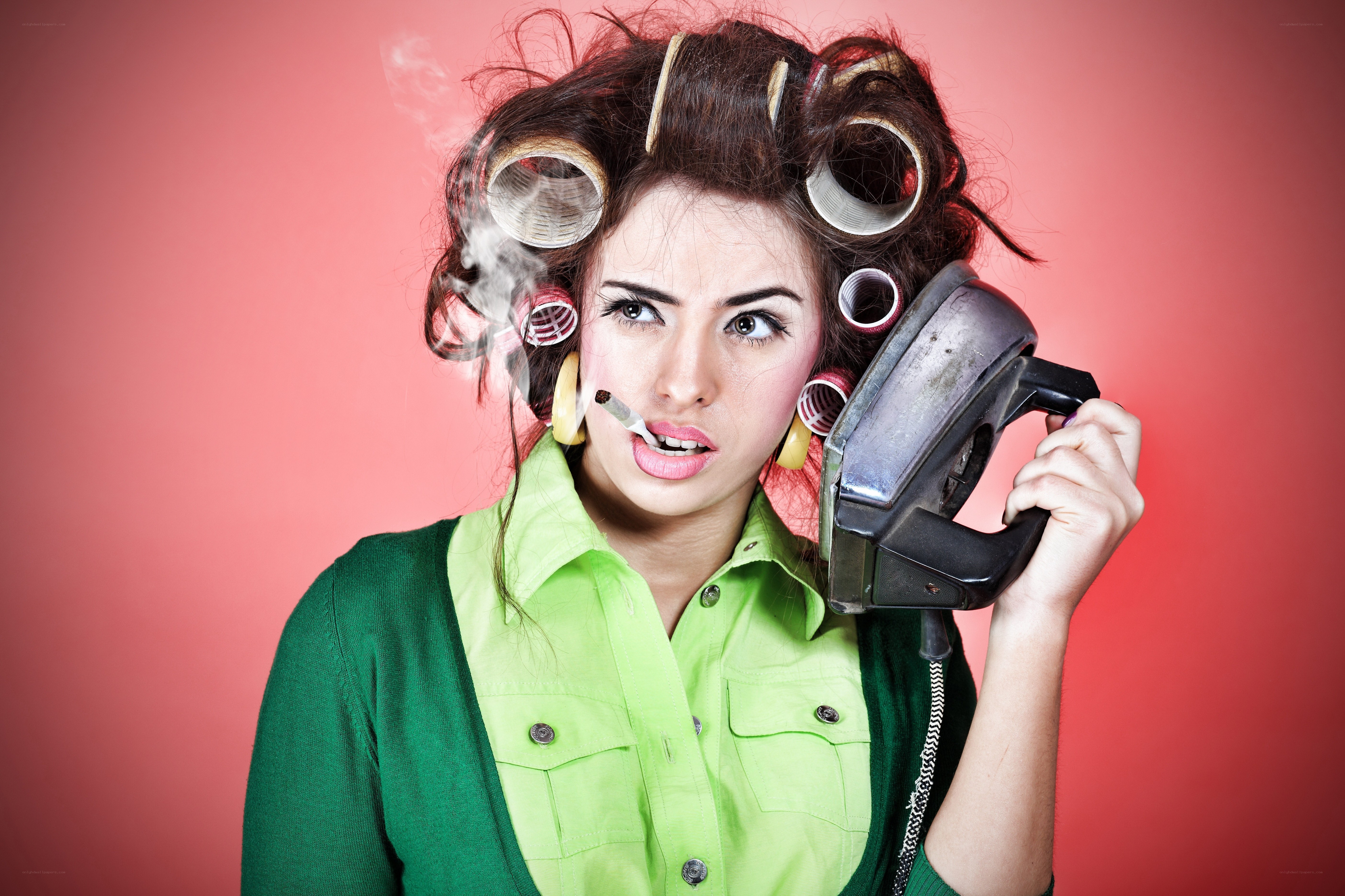 woman with curlers on phone
