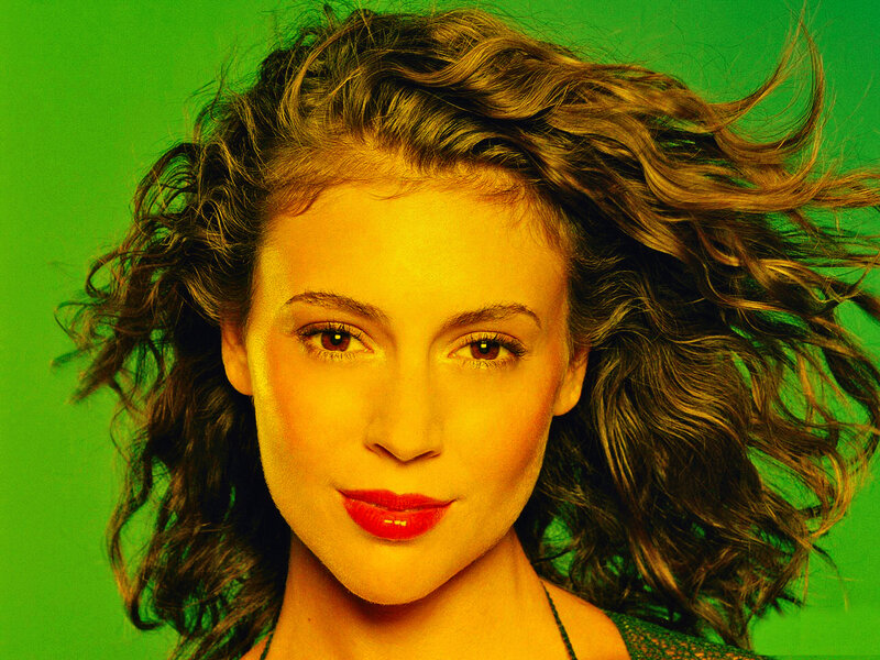 woman with curly hair against green background