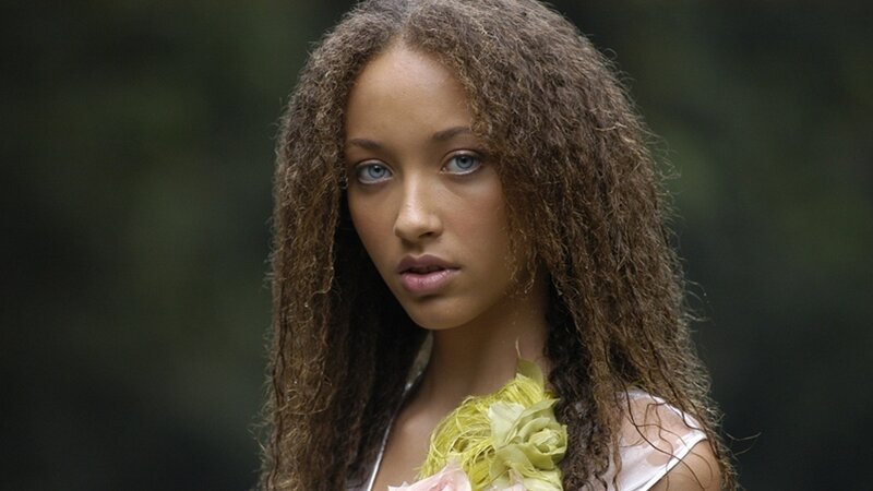 woman with curly hair and blue eyes