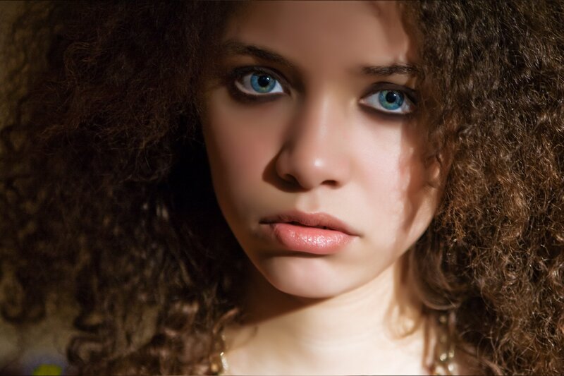 woman with curly hair and blue eyes