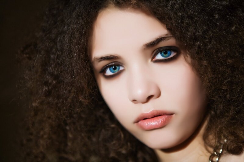 woman with curly hair and blue eyes