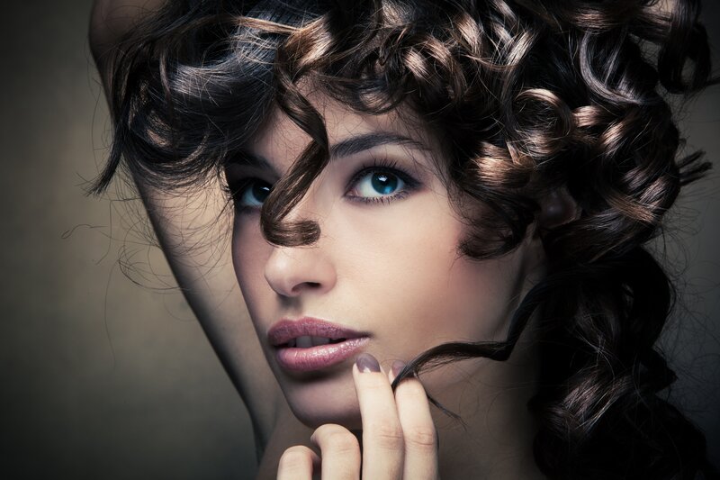 woman with curly hair and blue eyes