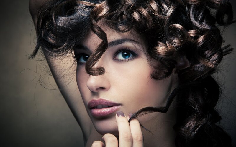 woman with curly hair and blue eyes