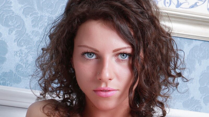 woman with curly hair and blue eyes