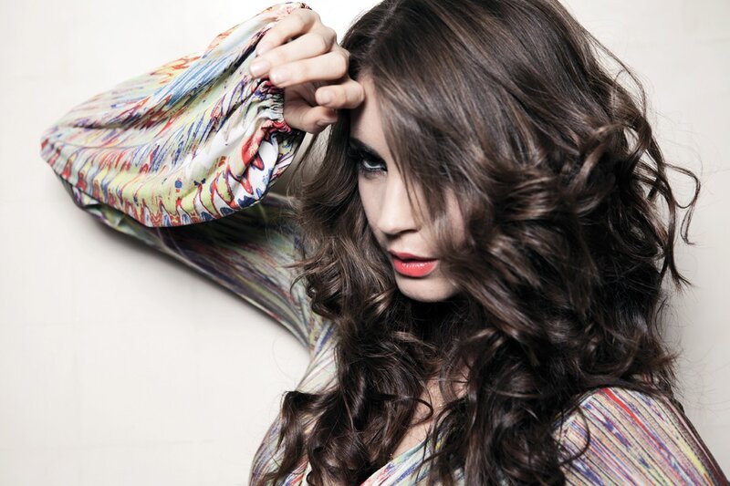 woman with curly hair and colorful top