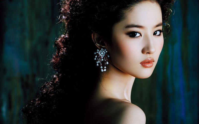 woman with curly hair and earrings