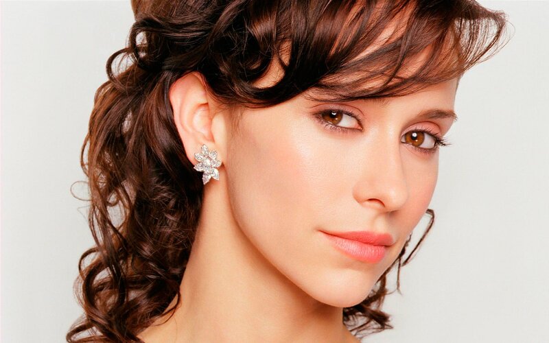 woman with curly hair and earrings