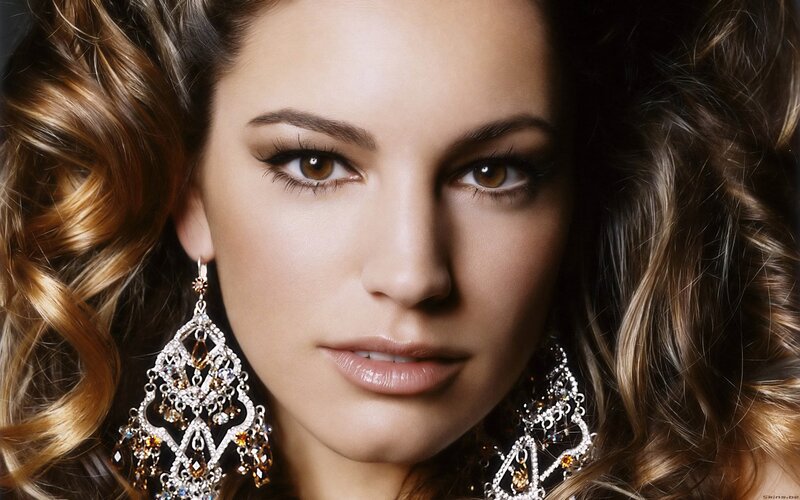 woman with curly hair and earrings