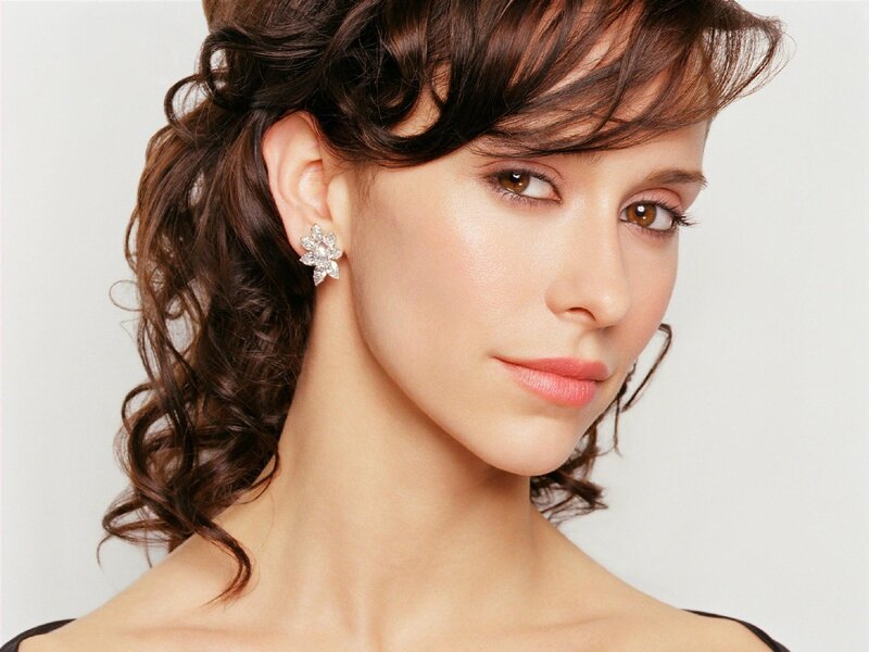 woman with curly hair and earrings