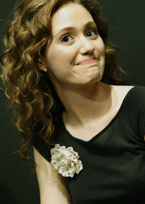 woman with curly hair and flower brooch
