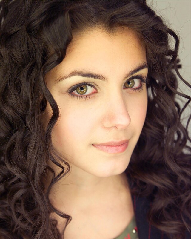 woman with curly hair and green eyes