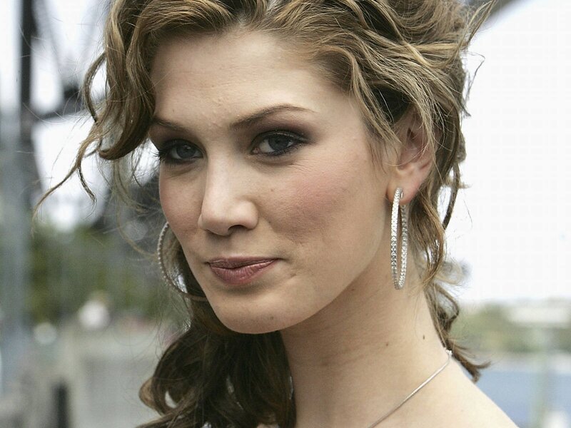 woman with curly hair and hoop earrings