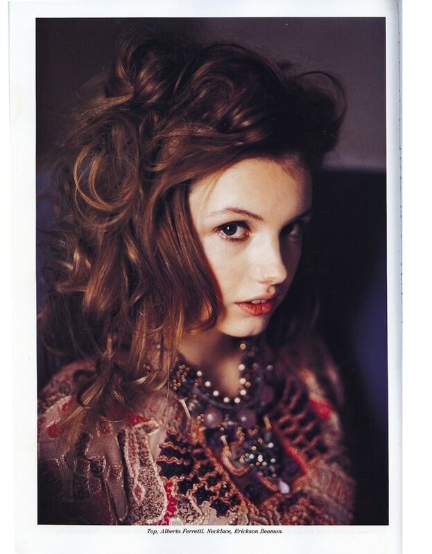 woman with curly hair and necklace