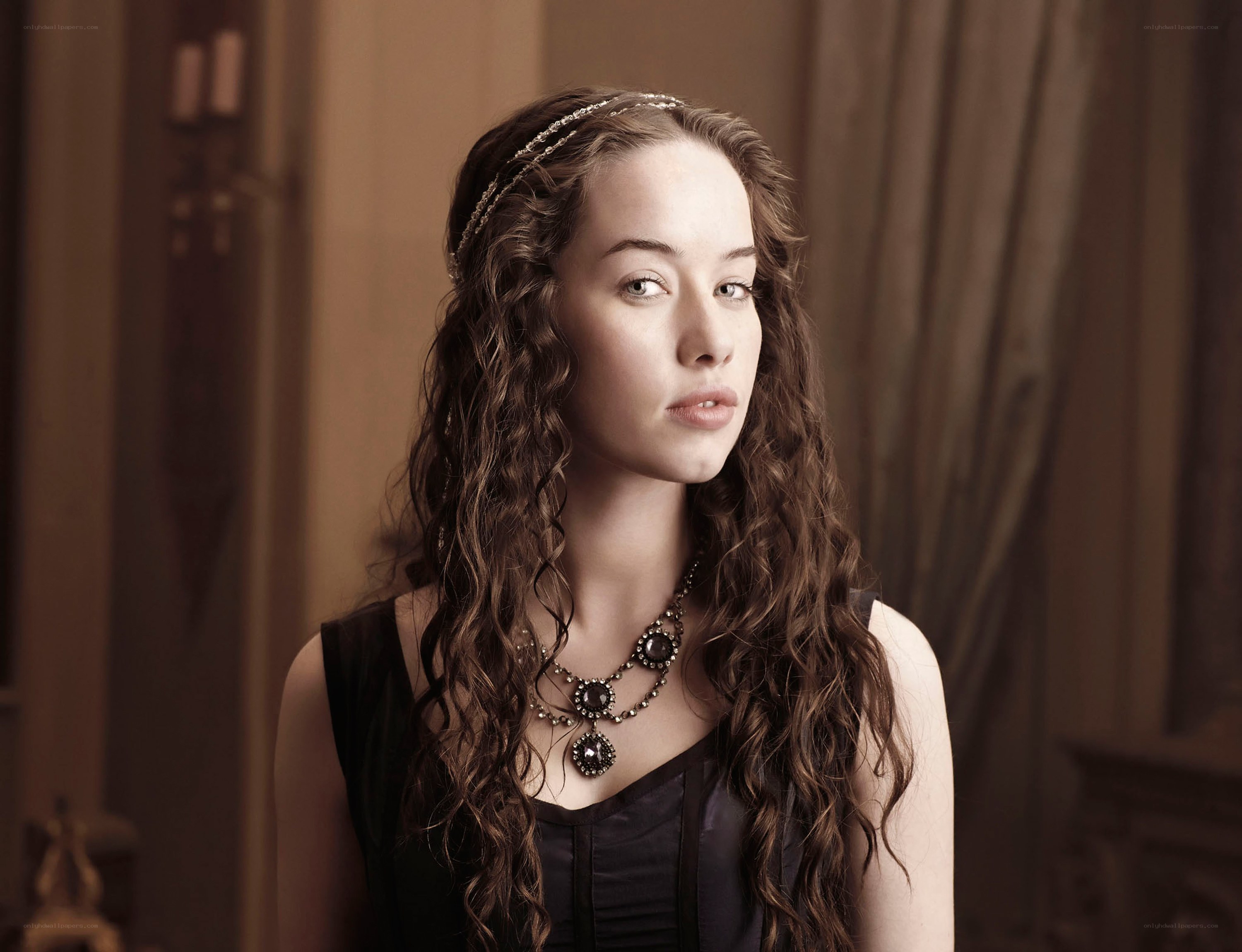 woman with curly hair and necklace