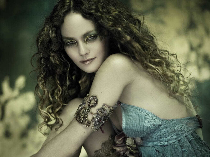 woman with curly hair and ornate bracelet