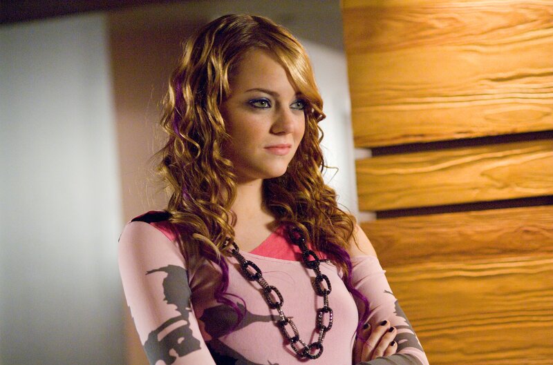 woman with curly hair and pink top