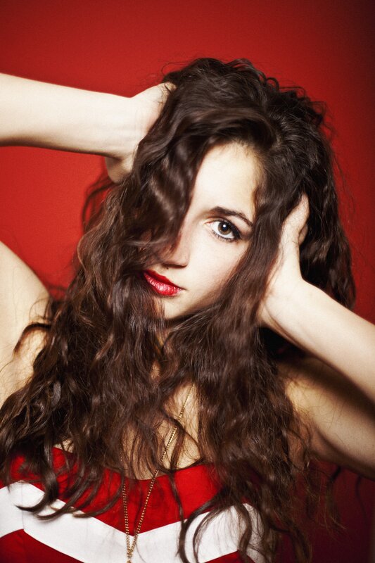 woman with curly hair and red lipstick