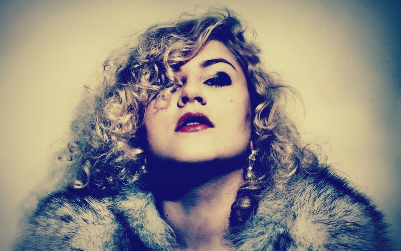 woman with curly hair and red lipstick