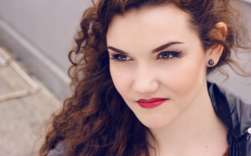 woman with curly hair and red lipstick