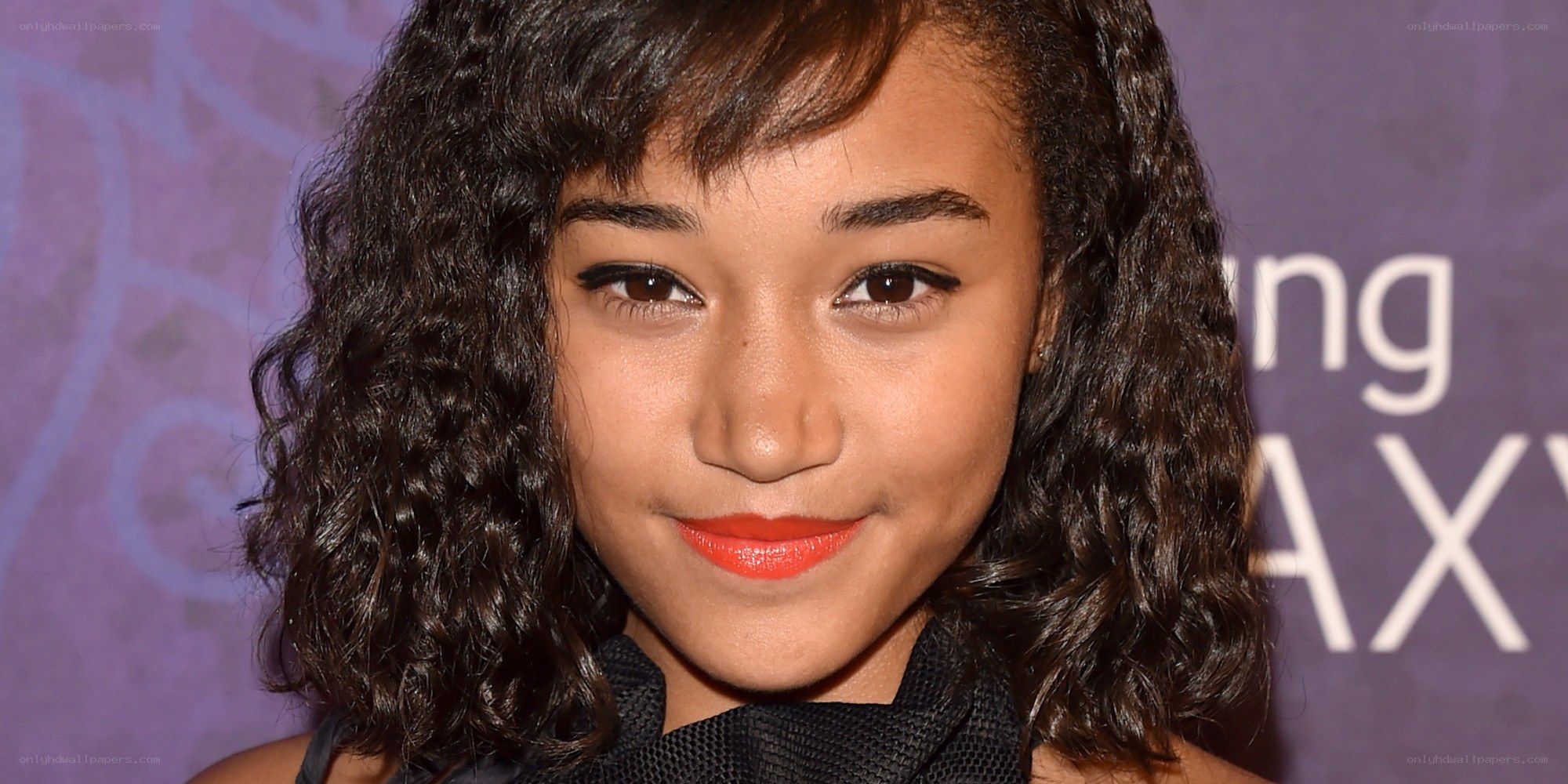 woman with curly hair and red lipstick