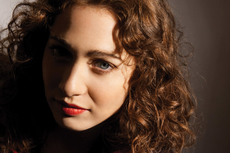 woman with curly hair and red lipstick