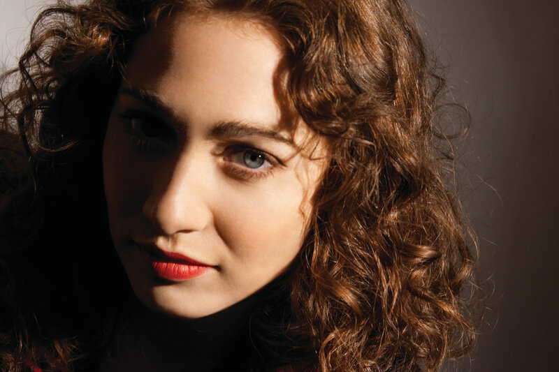 woman with curly hair and red lipstick