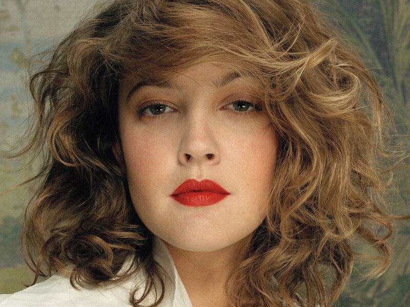 woman with curly hair and red lipstick