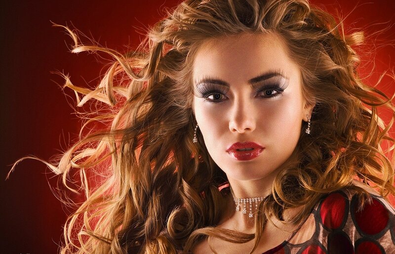 woman with curly hair and red makeup