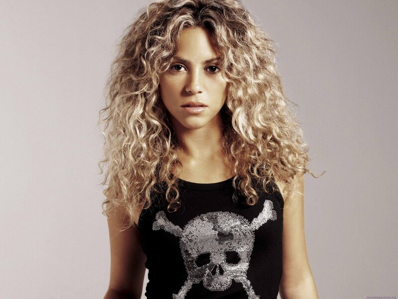 woman with curly hair and skull shirt