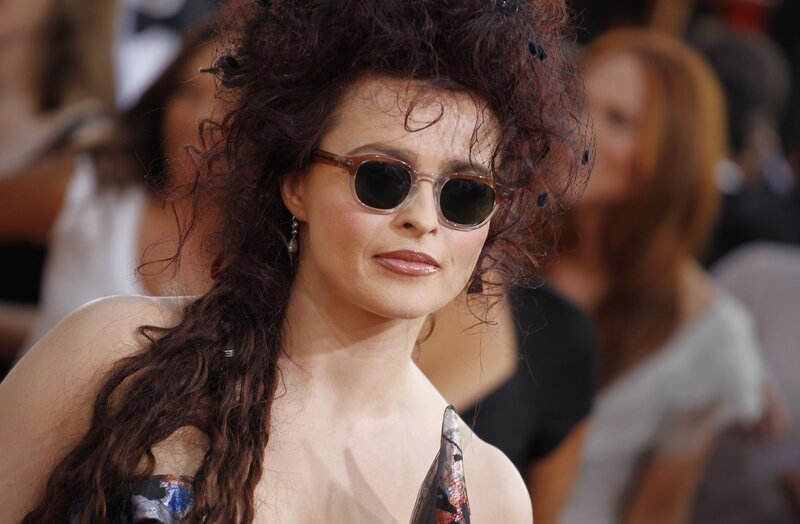 woman with curly hair and sunglasses