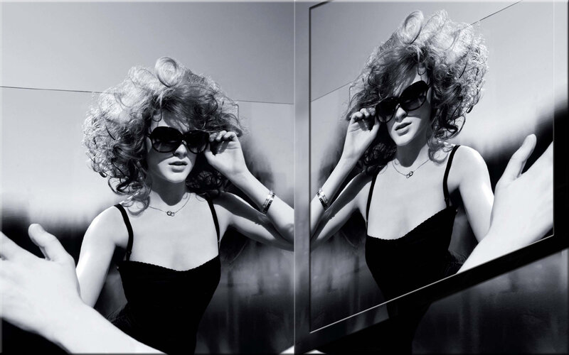 woman with curly hair and sunglasses